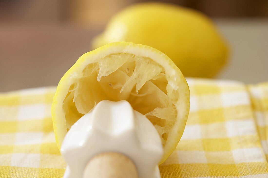 Squeezed lemon half with lemon reamer