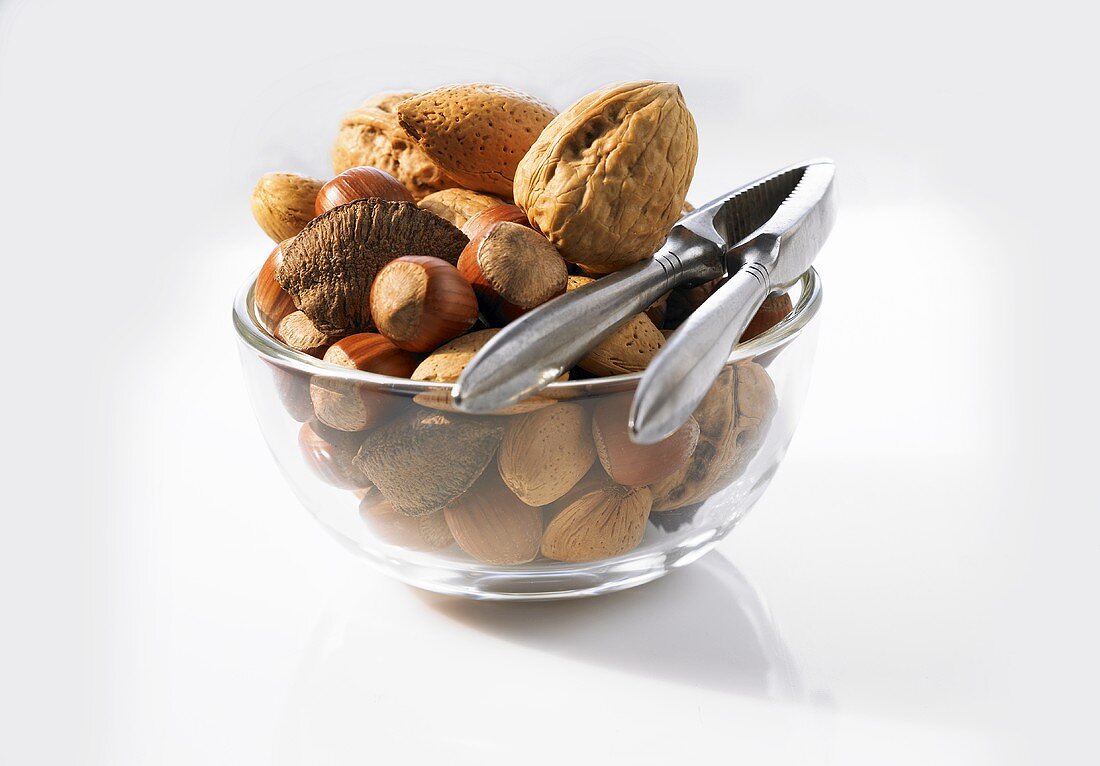 A bowl of nuts with nutcracker