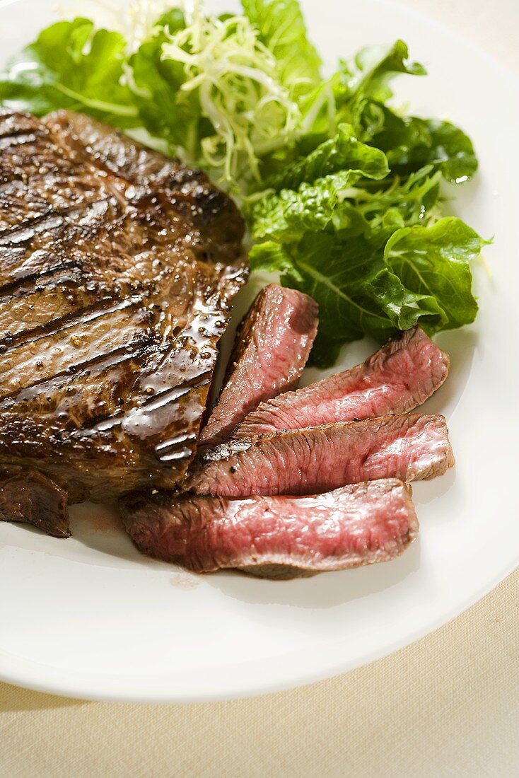 Partially Sliced Steak; Rare; Side Salad