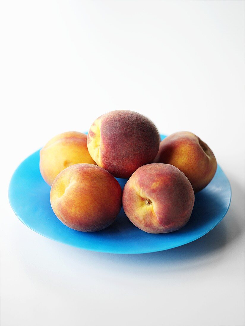 Peaches on a blue plate