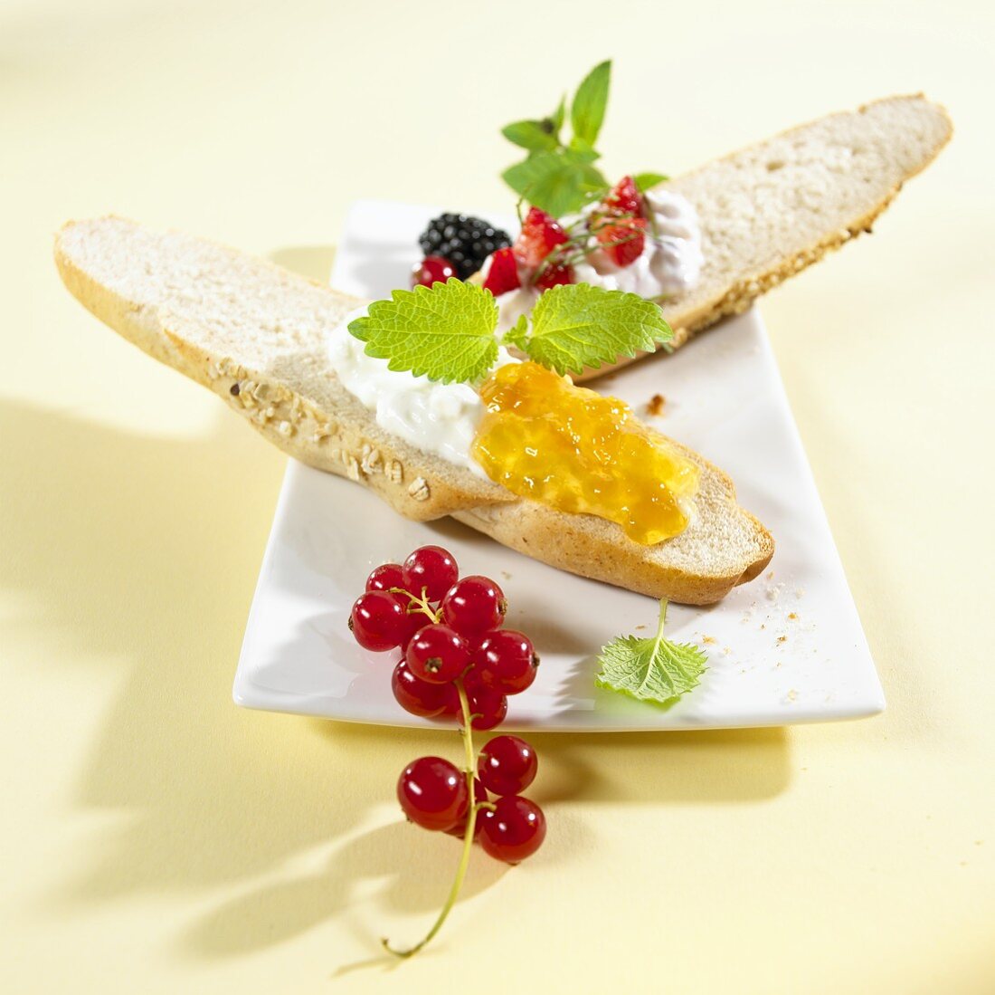 Grain baguette topped with jam, quark and berries