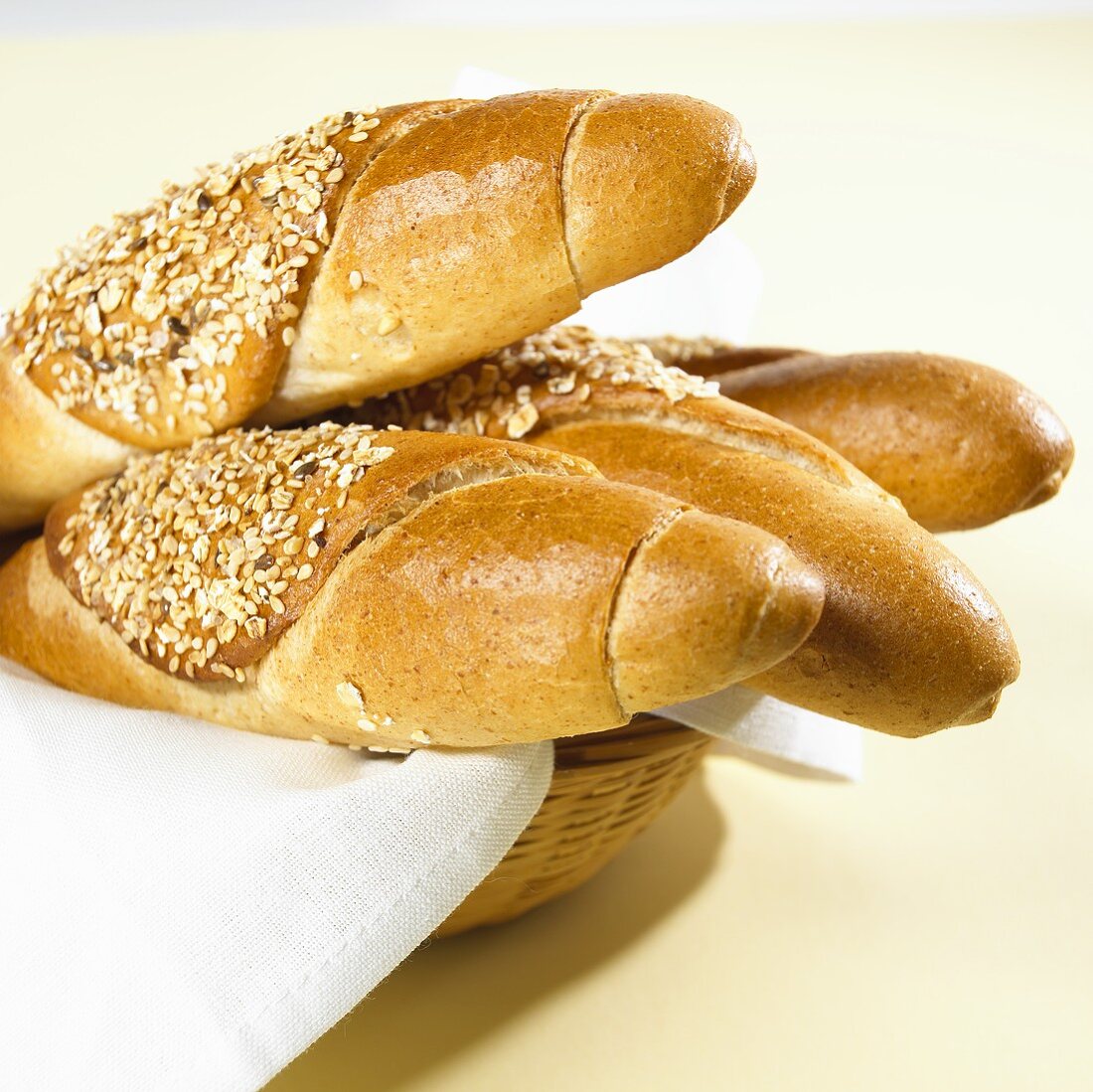 Several grain baguettes in a bread basket