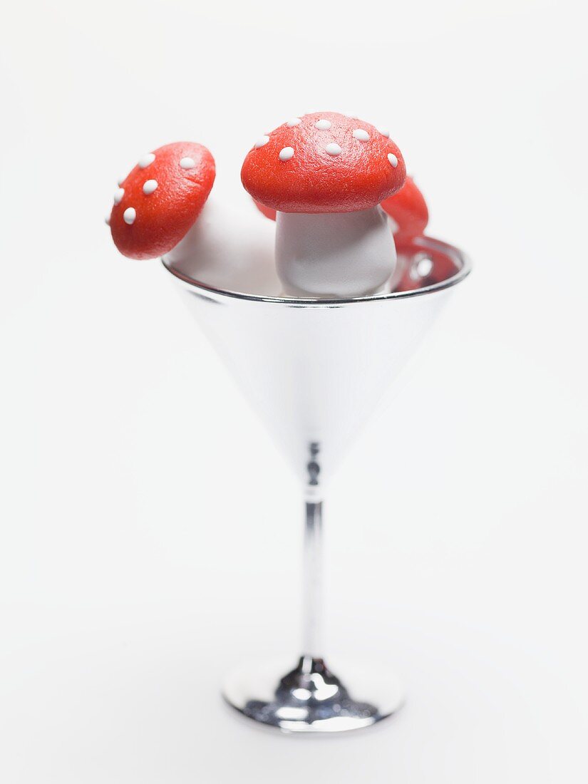 Marzipan fly agaric mushrooms in cocktail glass