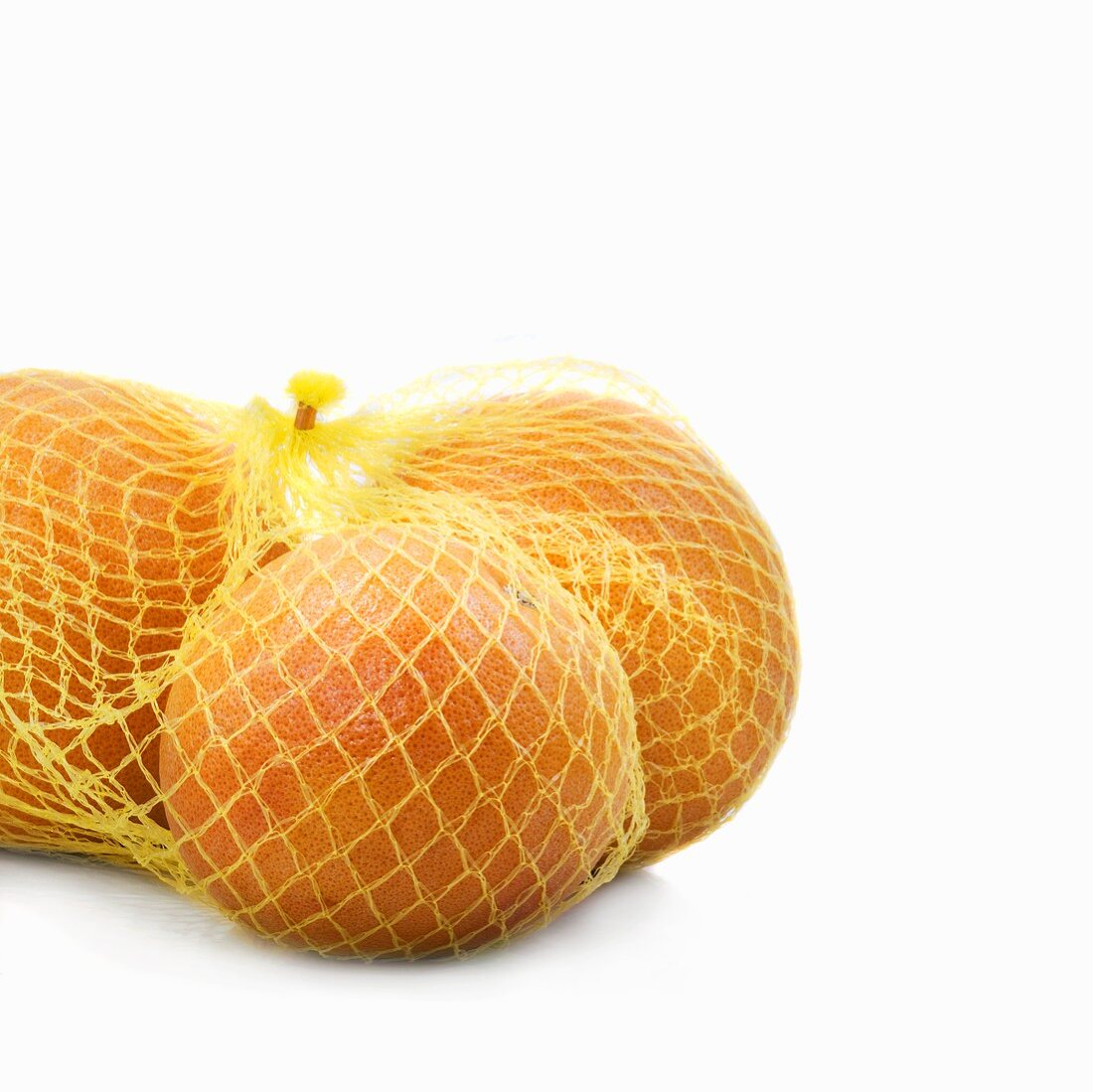 Three grapefruits in a net