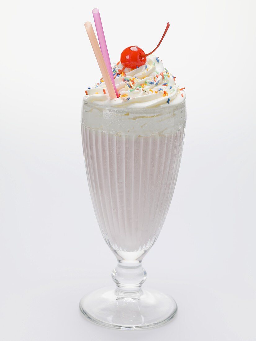 Milkshake with cream, sprinkles and cocktail cherry