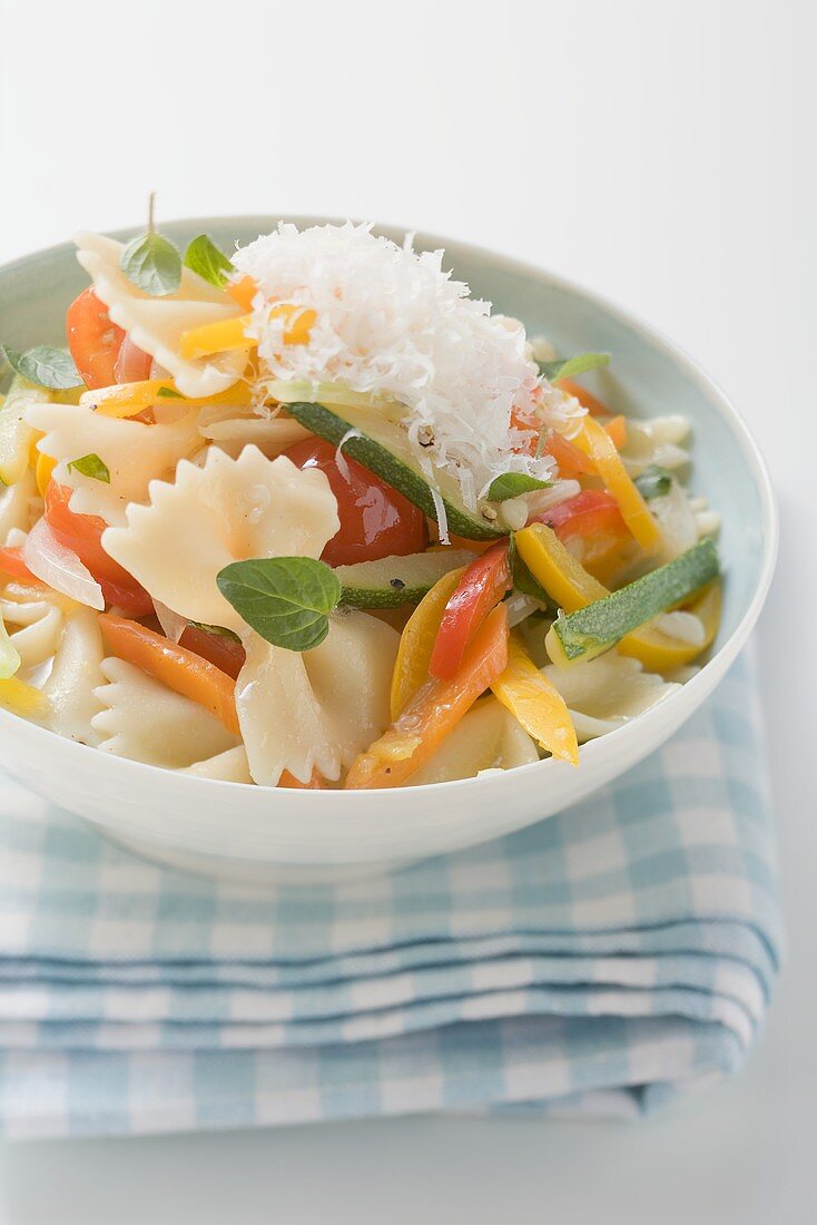 Farfalle primavera with vegetables and grated cheese