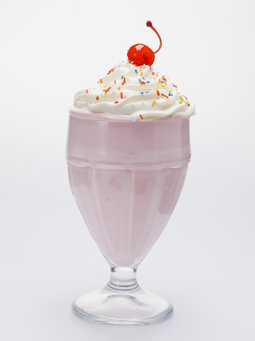 Milkshake with cream, sprinkles and cocktail cherry