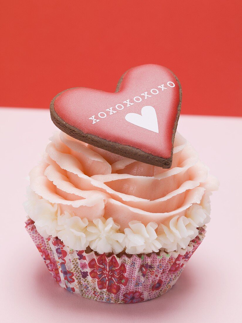 Cup cake with marzipan rose and pastry heart