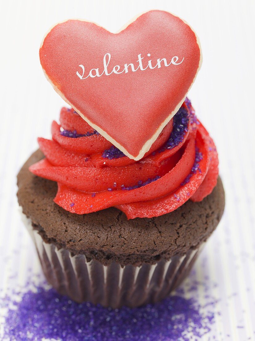 Chocolate muffin with red cream and vanilla heart
