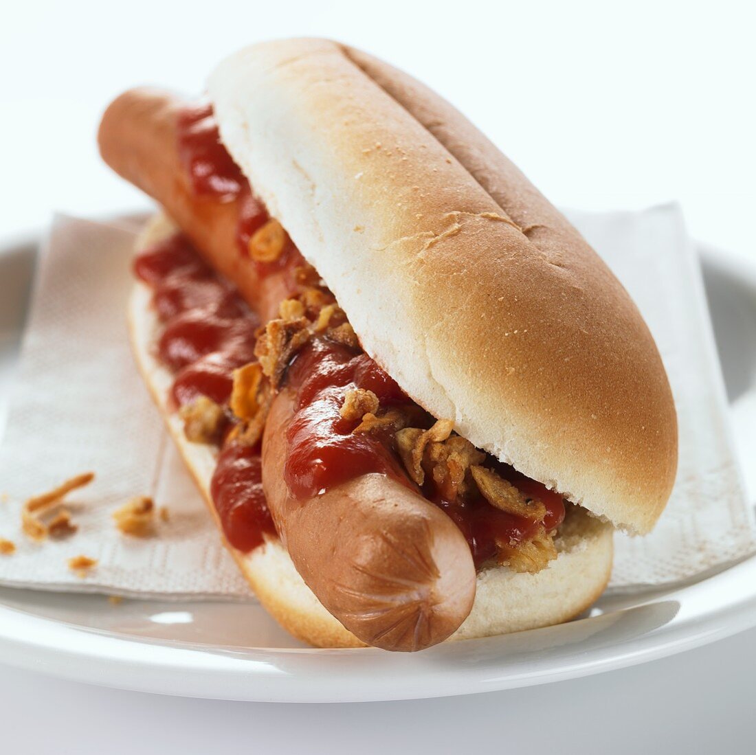 Hot dog with ketchup on plate