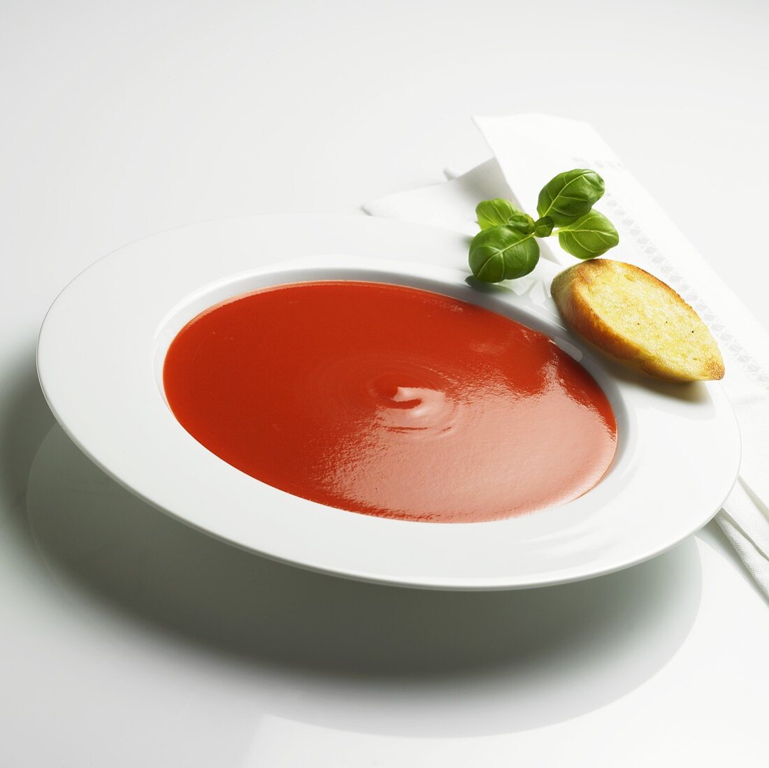 Tomato soup with toast and basil