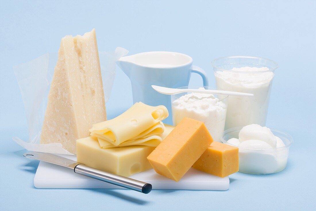 Still life with hard cheese, fresh cheese and milk