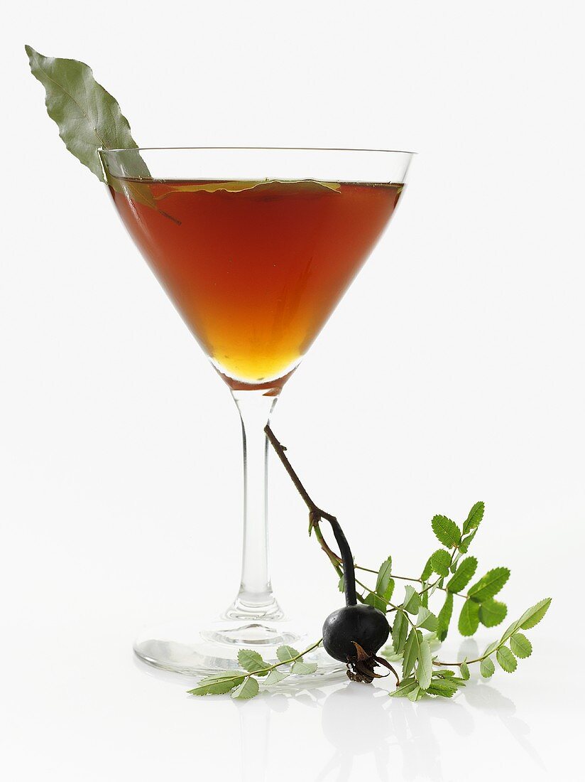 Tea with bay leaves in stemmed glass