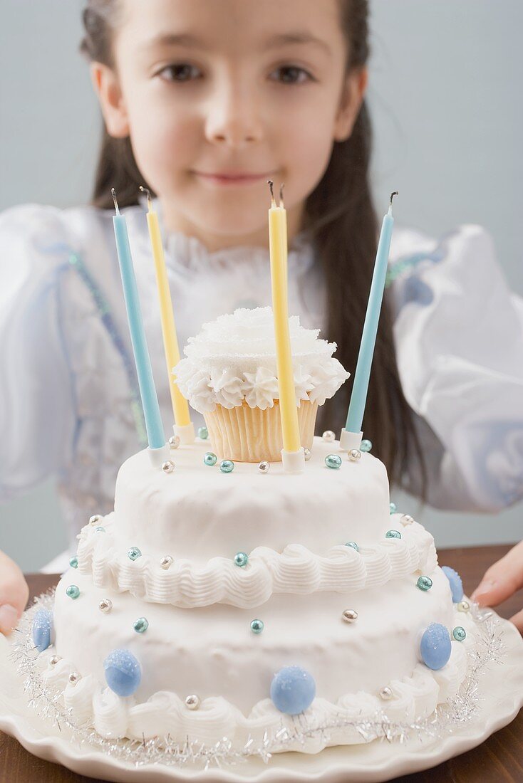 Little girl dressed as princess with birthday cake