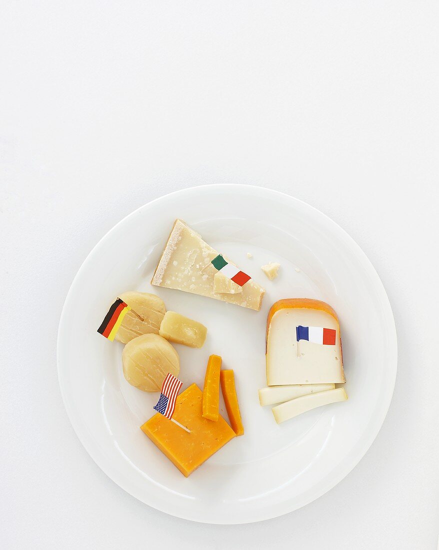 Various cheeses on plate with flags