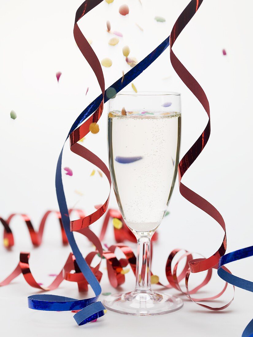 Glass of sparkling wine with party decorations