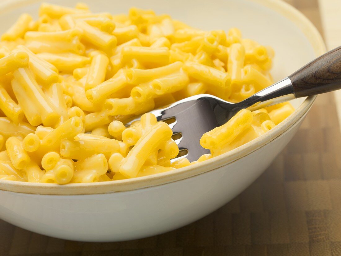 Macaroni and cheese in a bowl with a fork