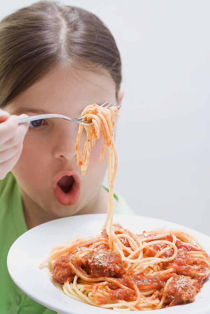 Girl about to eat a forkful of spaghetti