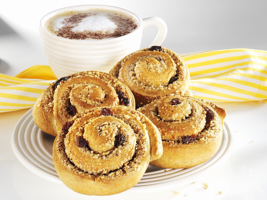 Wholemeal cinnamon buns with nuts and raisins, with coffee