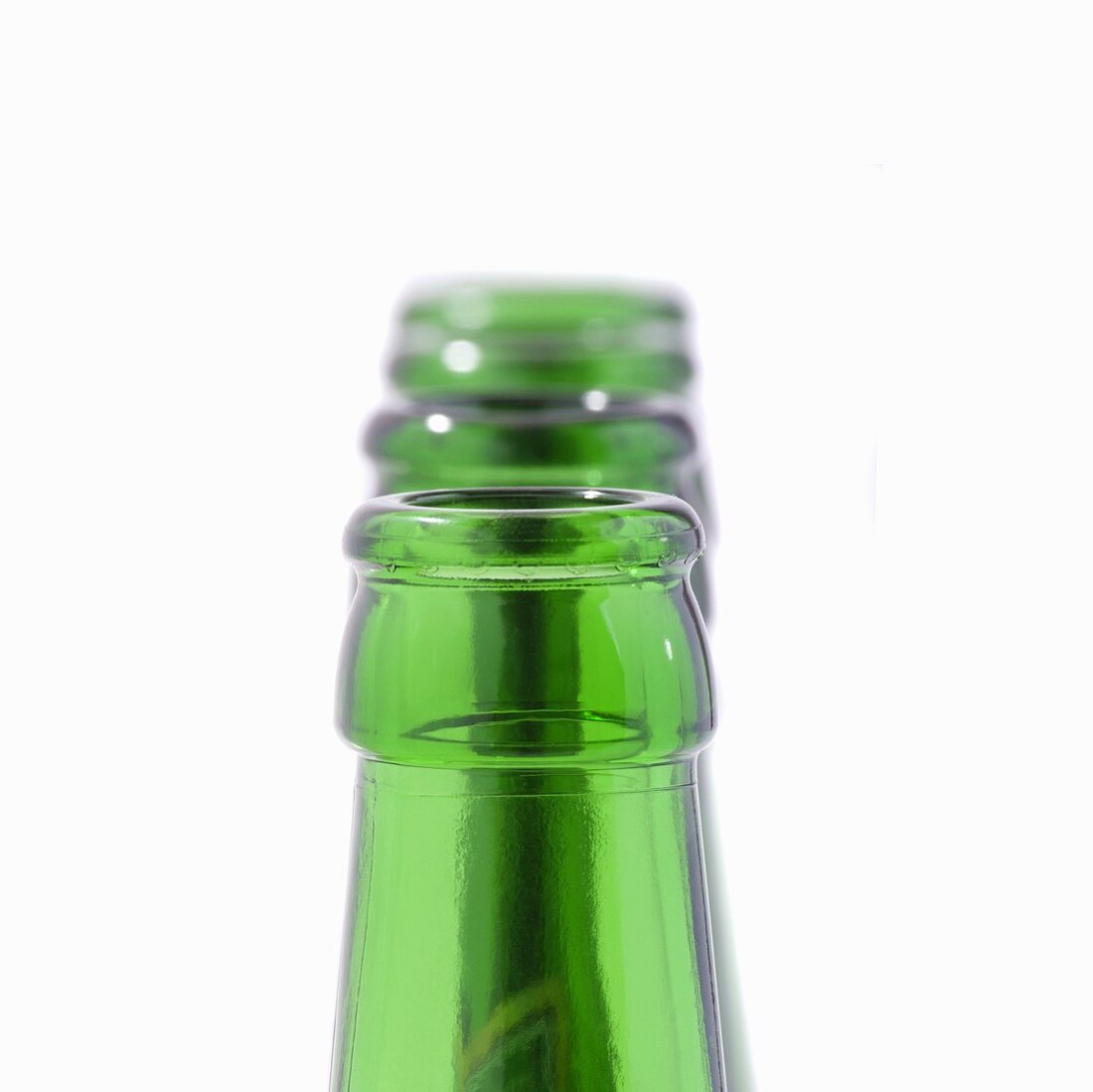 Green beer bottle necks in a row