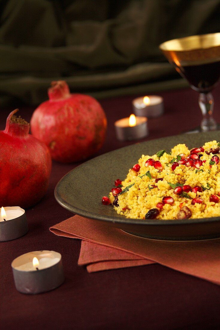 Dish of Pomegranate Couscous; Candles and Pomegranates