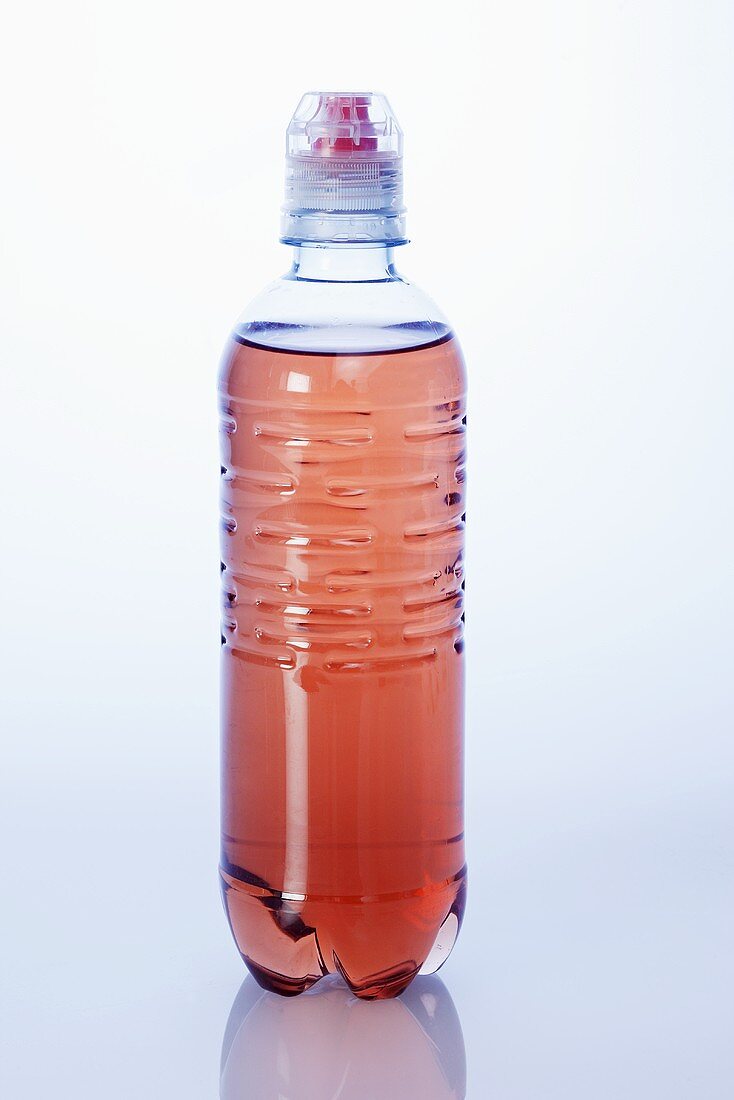 Red energy drink in plastic bottle