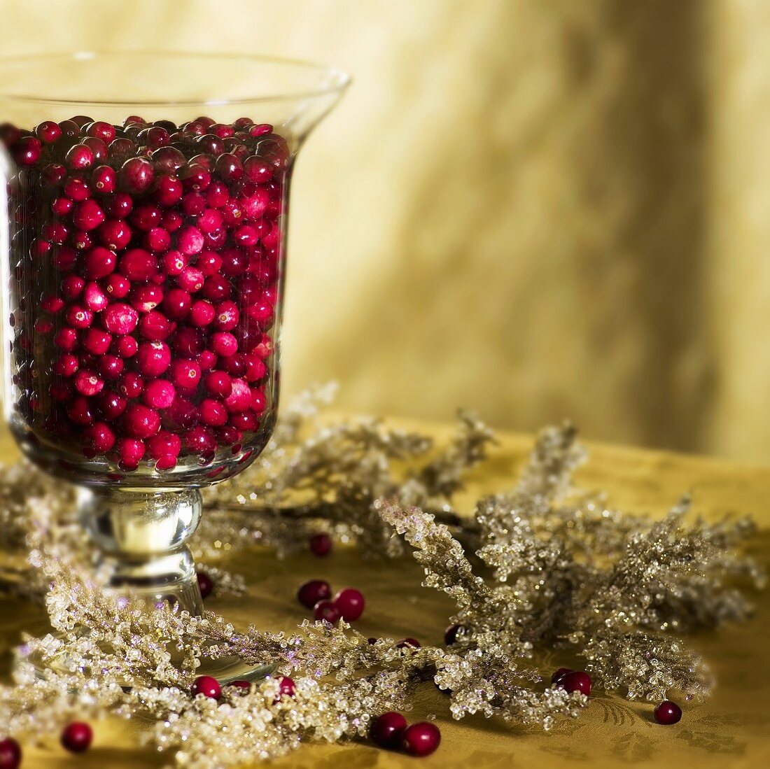 Cranberries in Hurricane Vase as Christmas Decoration