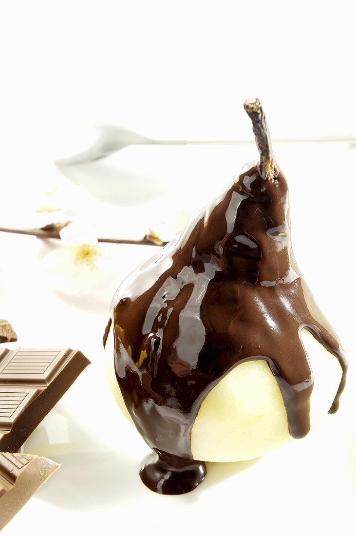 A pear with chocolate sauce