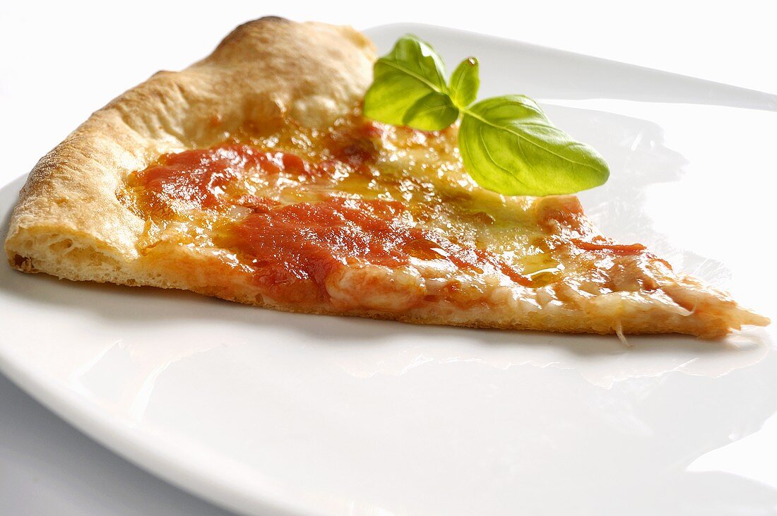A slice of pizza with basil