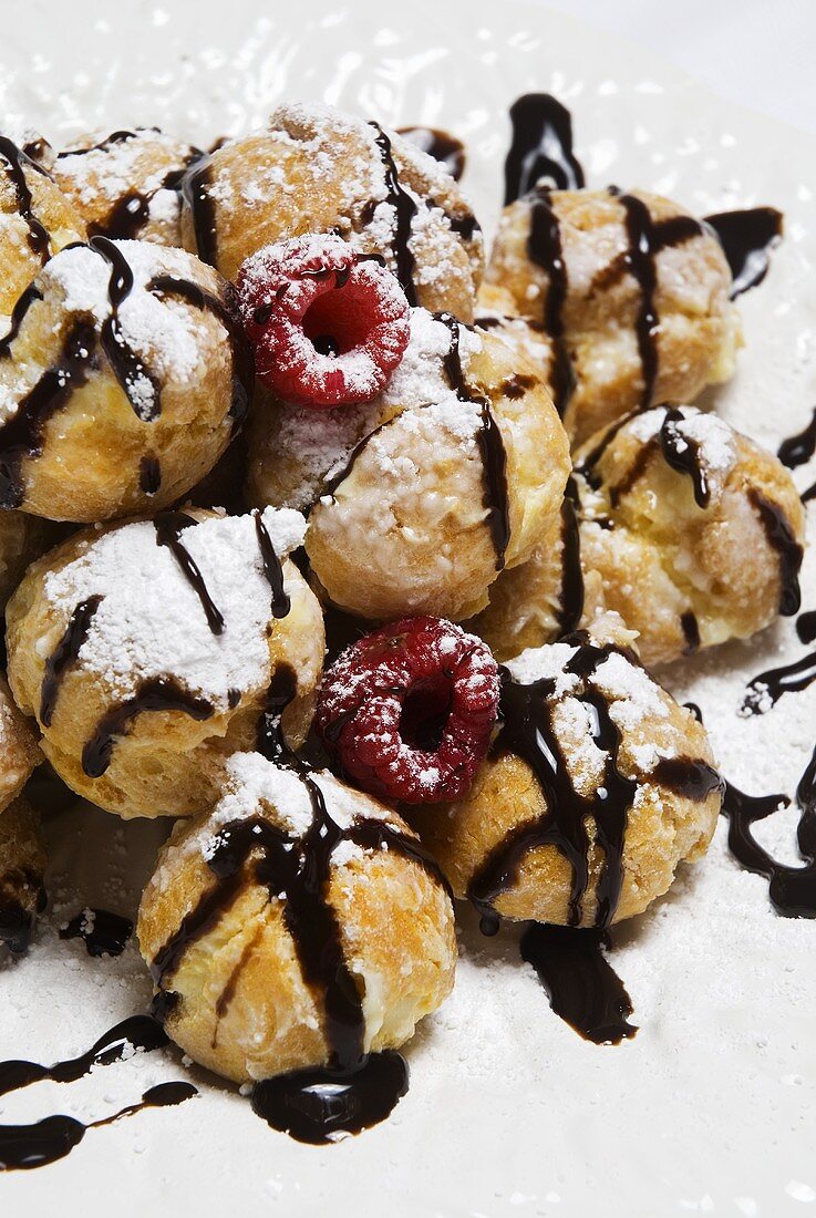 Profiteroles with Chocolate Syrup, Powdered Sugar and Raspberries