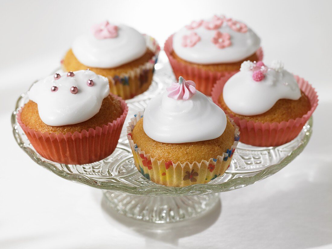 Iced and decorated cupcakes on a cake stand