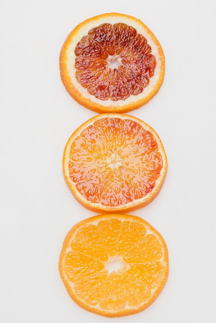 Slices of three different oranges from above
