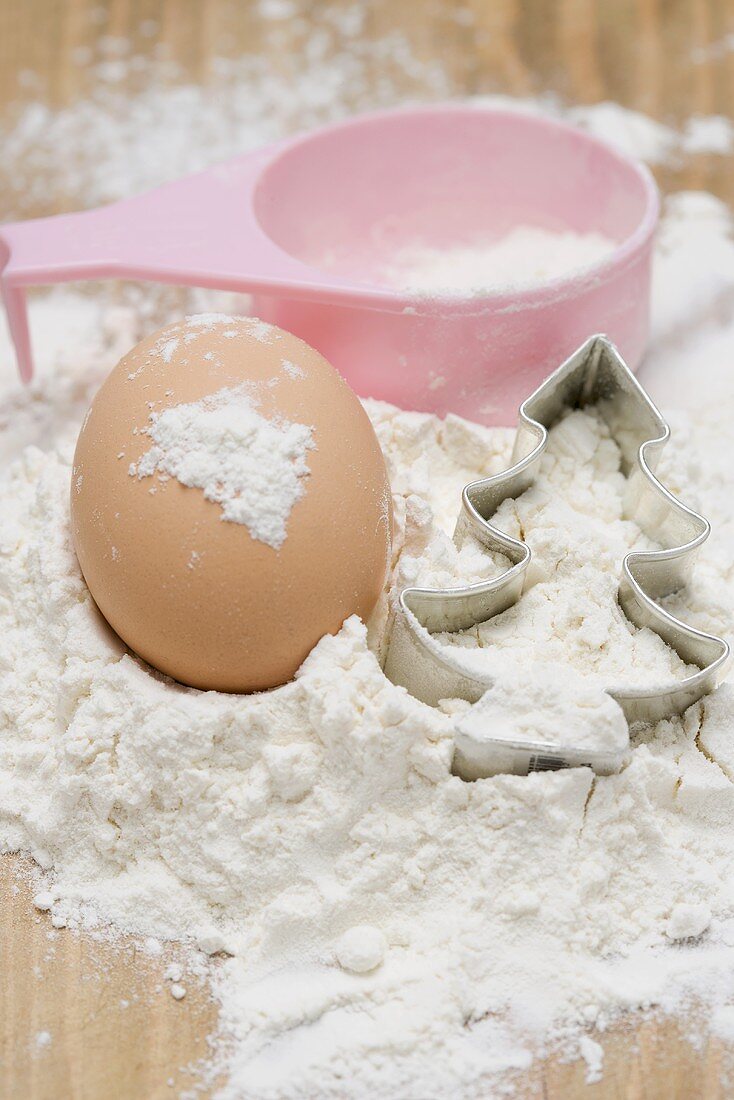 Egg, flour, cutter and measuring spoon