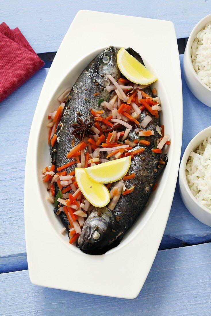 Two trout with vegetables and rice