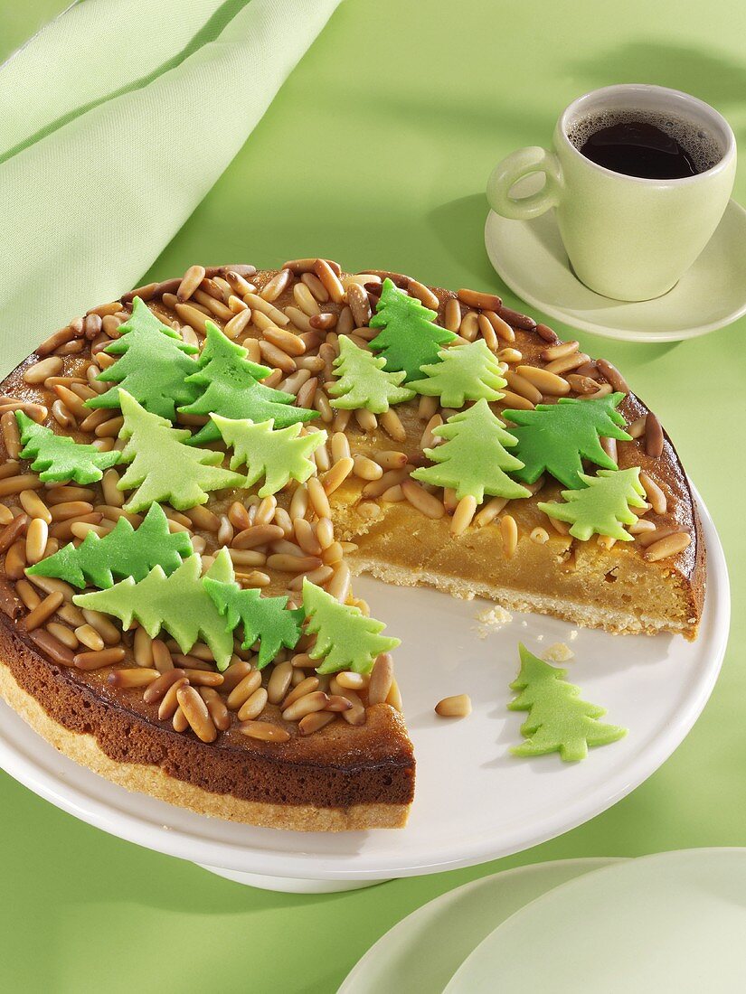 Marzipan cake with pine nuts and marzipan fir trees