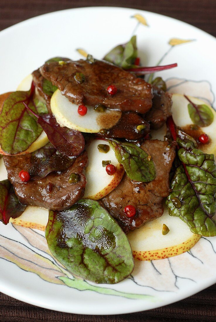 Slices of beef fillet on pear and sorrel