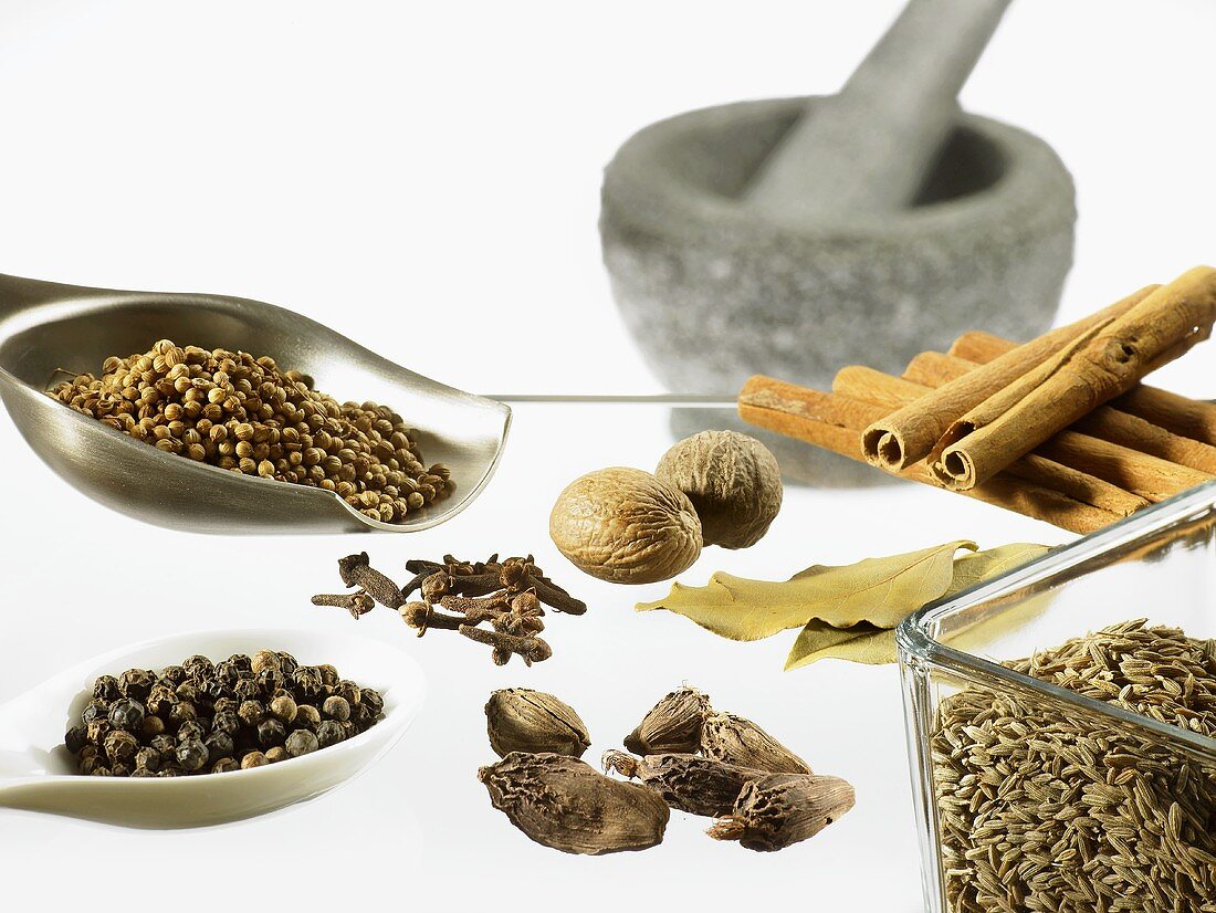 Spices for garam masala with stone mortar and pestle