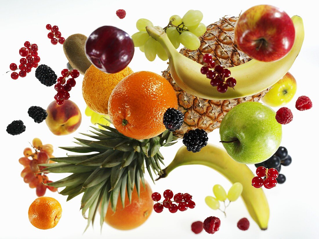 Various types of fruit against white background