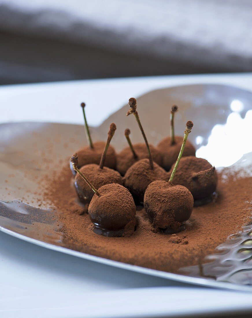 Chocolate-dipped cherries with cocoa powder