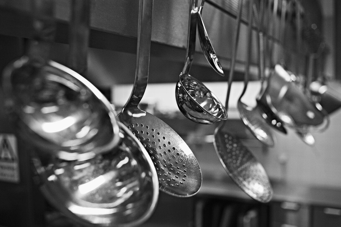 Ladles and skimmers hanging up (black & white photo)