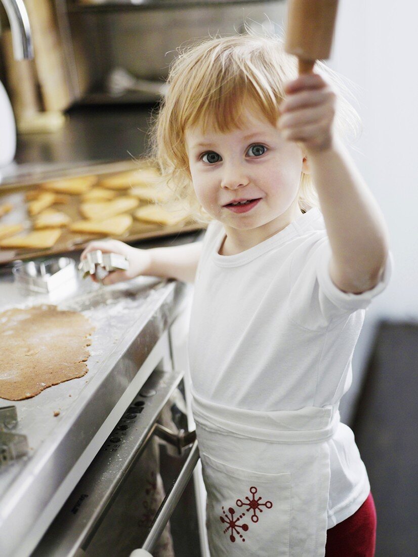 Little girl baking biscuits