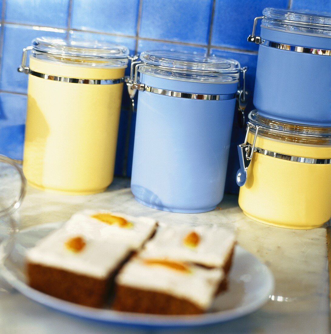 Pieces of cake and coloured storage jars