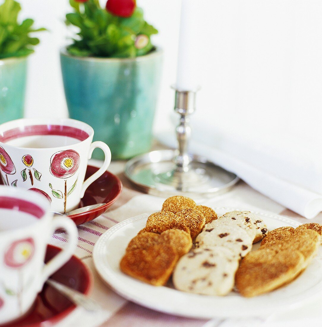 Plate of assorted biscuits, cups and saucers
