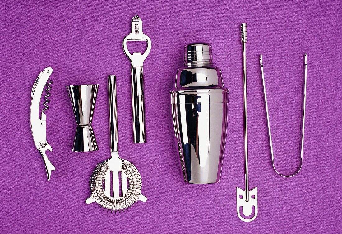 Bar utensils against purple background