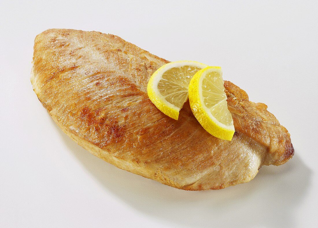 Roast turkey breast fillet with lemon slices