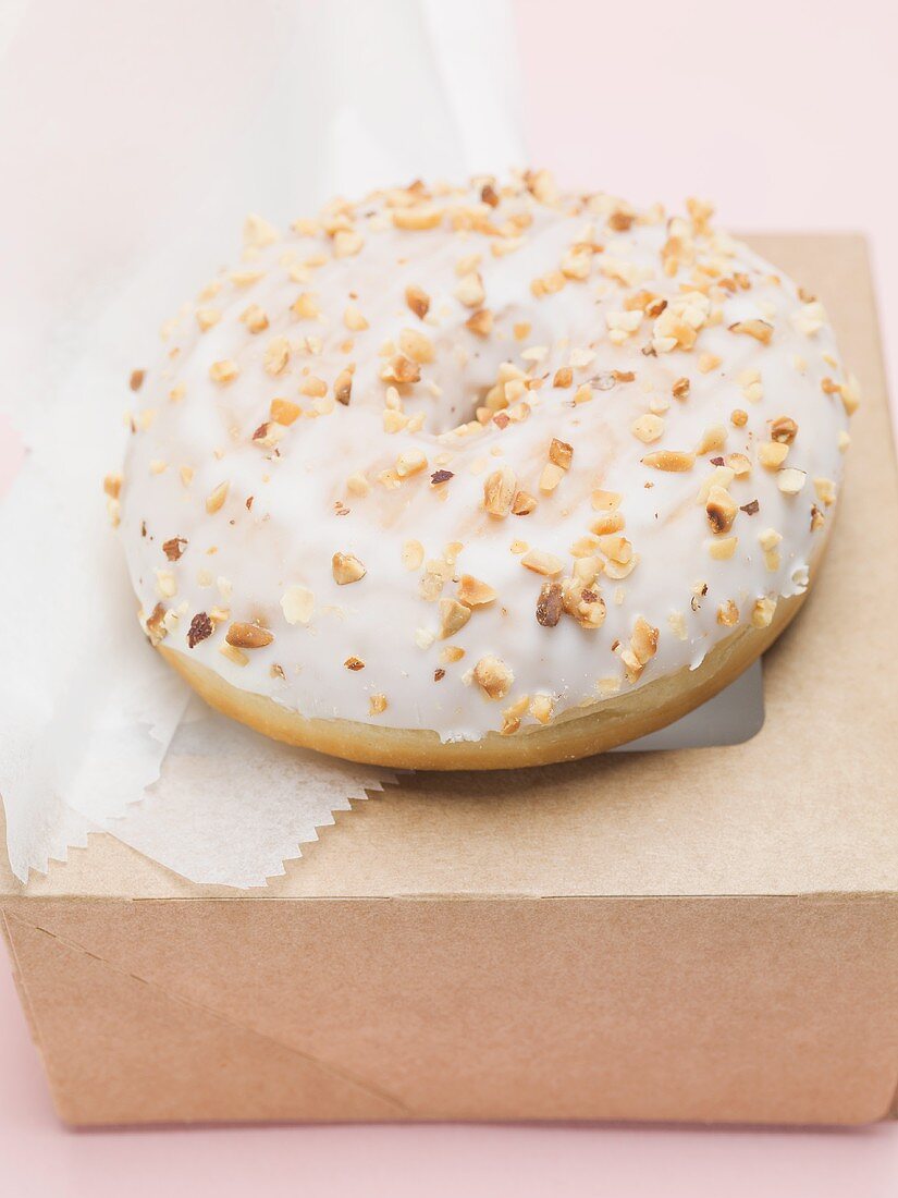 Iced doughnut with chopped nuts
