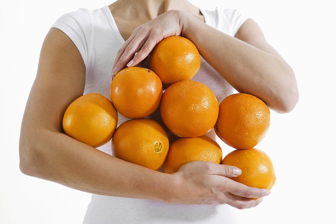 Woman holding fresh oranges
