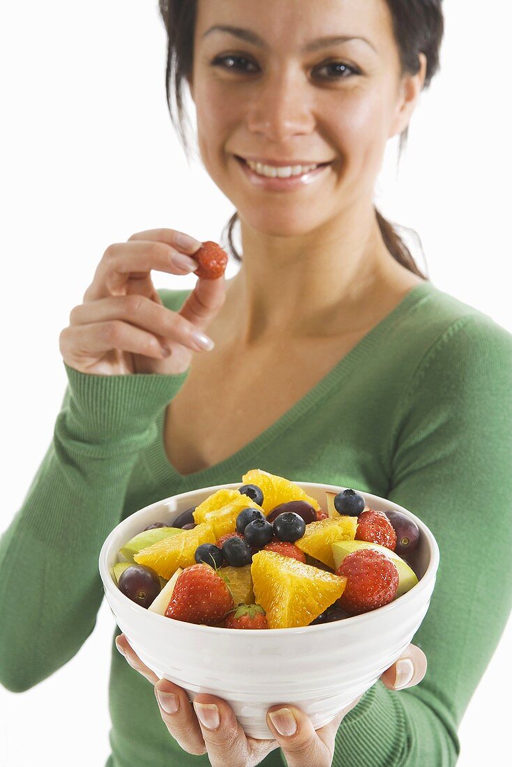 Woman eating fruit salad