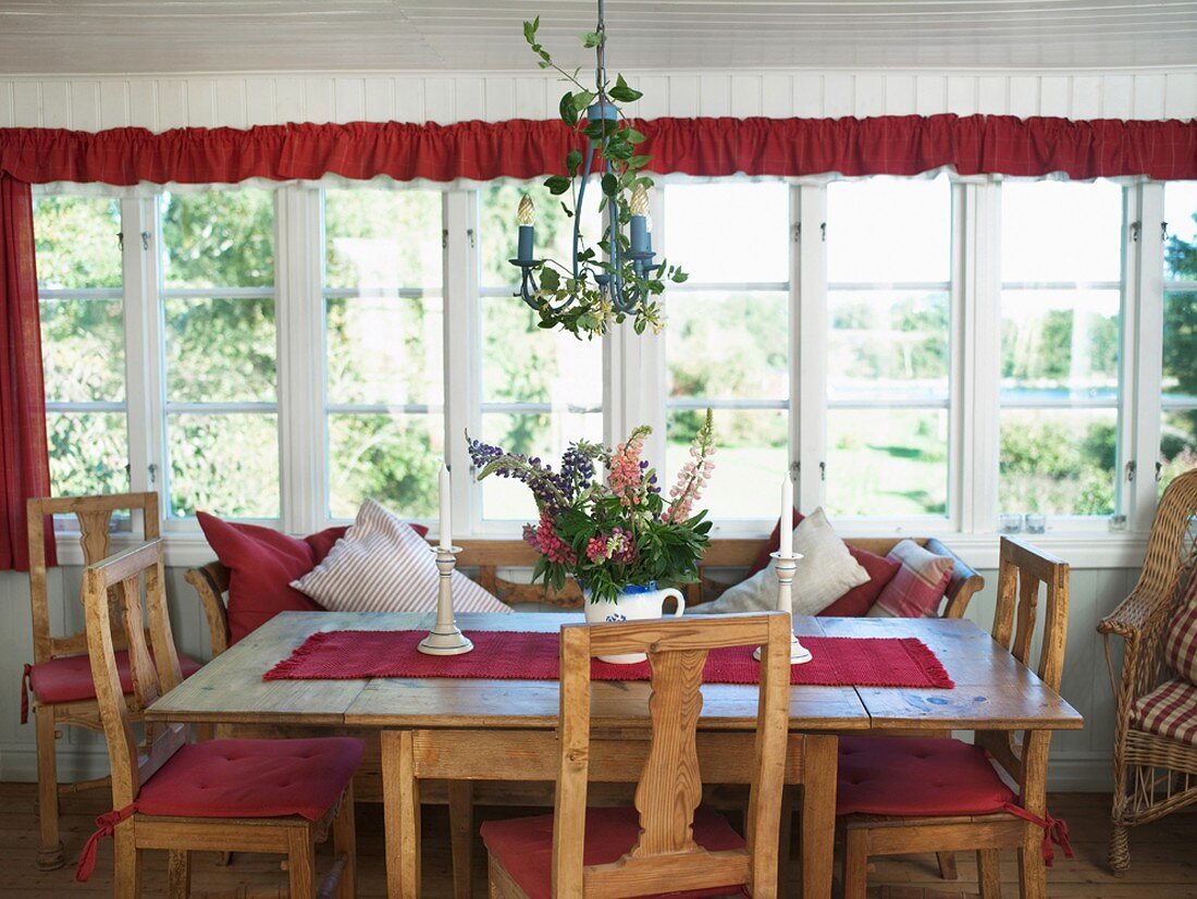 Rustic wooden table and chairs on glazed verandah