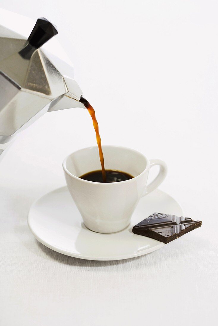 Pouring espresso into cup